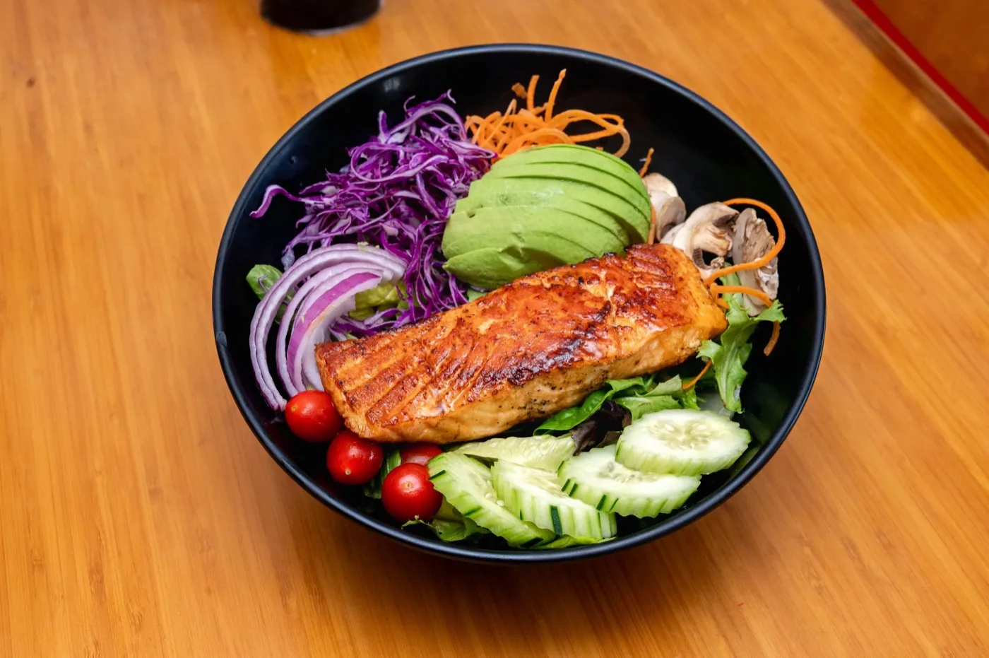 Fresh salad topped with grilled salmon